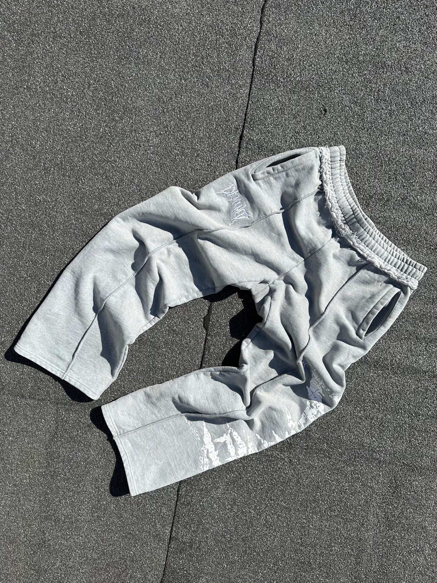 GREY CRACKED LOGO PANTS